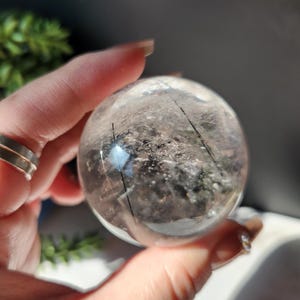 High quality black tourmaline in quartz  sphere with rainbows.