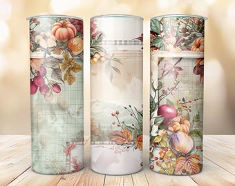 May include: Three stainless steel tumblers with fall-themed designs. The designs feature a variety of autumnal elements, including pumpkins, leaves, berries, and apples. The tumblers are all white with a vintage-inspired look.