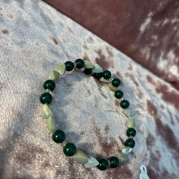 Memory wire Bracelet with #6 Tiger’s eye with small tooth looking shell beads. bracelet is a wrap.