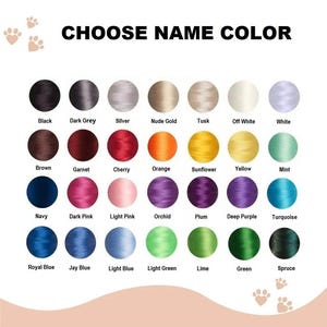 May include: A color chart with 28 thread color options for personalization. The colors include black, grey, silver, gold, white, brown, red, orange, yellow, green, blue, and purple. Text at the top reads "CHOOSE NAME COLOR."