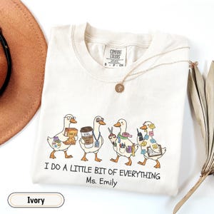 Personalized paraprofessional Comfort Colors shirt featuring funny goose characters carrying school supplies, coffee, snacks, and classroom essentials with custom teacher name, perfect gift for teacher aides, paraeducators, SPED staff, and RBTs.
