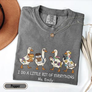 Personalized paraprofessional Comfort Colors shirt featuring funny goose characters carrying school supplies, coffee, snacks, and classroom essentials with custom teacher name, perfect gift for teacher aides, paraeducators, SPED staff, and RBTs.