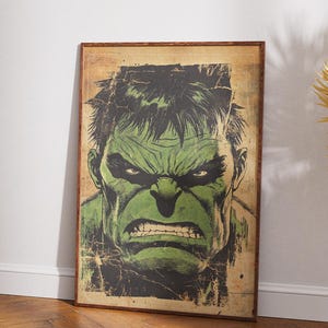 May include: A framed print featuring a close-up of the Hulk's face. The artwork showcases the Hulk's green skin, furrowed brow, and angry expression. The print has a distressed, vintage look, with a brown wooden frame.
