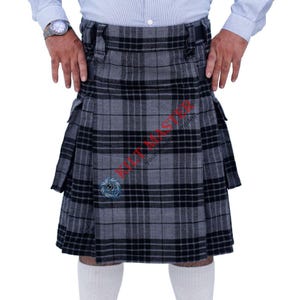 May include: A gray and black kilt with a plaid pattern. The kilt has two pockets on the sides and a belt with buckles.