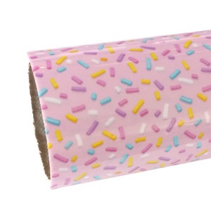 May include: Pink vinyl with a pattern of colorful sprinkles.