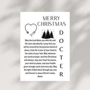 May include: A white Christmas card with the text "MERRY CHRISTMAS DOCTOR". The card features a heart-shaped stethoscope, Christmas trees, and a religious message. A thoughtful gift for a doctor.