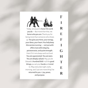 May include: A white print with a silhouette of two firefighters with a hose and flames. The word "FIREFIGHTER" is vertically displayed. Text honours firefighters' work, energy, ideas, and heart.
