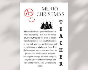 May include: A white card with the words "MERRY CHRISTMAS TEACHER" in black text. The card includes a red "A+" grade mark with a smiley face, and a graphic of three Christmas trees. A prayer is also printed on the card.