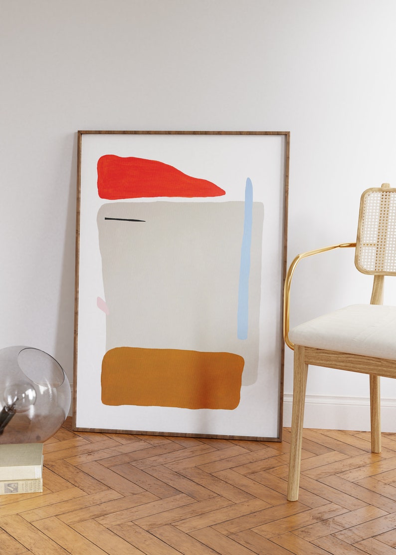 May include: A framed abstract art print with a white background and geometric shapes in red, orange, blue, and black.