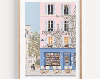 Puede incluir: Una impresión artística enmarcada representa una librería parisina con fachada rosa y detalles azules. El edificio tiene varias ventanas con contraventanas azules y una planta trepadora. Mesas y sillas están dispuestas frente a la librería.