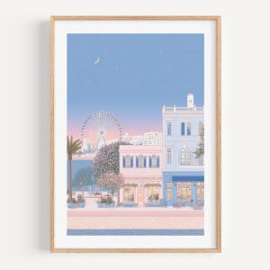 May include: A framed art print depicts a pastel-colored cityscape at dusk. A Ferris wheel, buildings, and a palm tree are visible under a blue sky with a crescent moon. The buildings have blue, pink, and white facades.