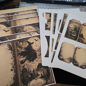 May include: A collection of printed paper sheets featuring vintage-style Halloween illustrations, including a witch on a broomstick, jack-o'-lanterns, bats, and haunted landscapes. The designs include rectangular tags and decorative borders with sepia tones.