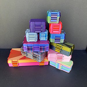 May include: A white ceramic mug with a black handle and the text "But First, Coffee" in a black, handwritten-style font. The mug is on a white surface.