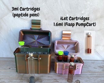 May include: Two rectangular storage cases with hinged lids. The left case is dark bronze and holds 3ml cartridges for peptide pens. The right case is light pink and holds 1.6ml iLet Fiasp PumpCart cartridges. Each case has internal slots for vials.