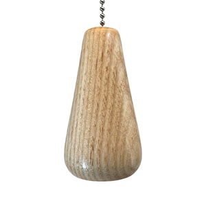 May include: A wooden light pull with a teardrop shape and a silver chain.