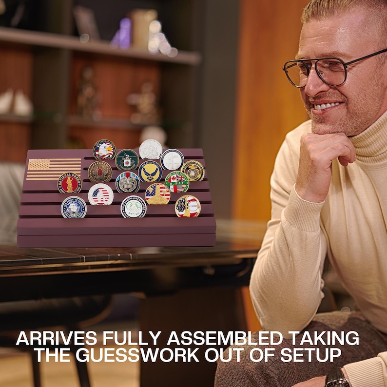 May include: A display stand with a burgundy finish, holding a collection of military challenge coins. The stand features an American flag design. The coins are round with various emblems and colors.