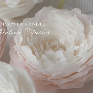 May include: Close-up of a white and pink flower candle. The candle is made to look like a peony flower. The text "FLOWER CANDLE Online Classes" is visible in the image.