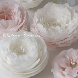 May include: Close-up of four white and pink flower-shaped candles. The candles are arranged in a semi-circle on a white surface. The text "FLOWER CANDLE Online Classes" is visible in the center of the image.