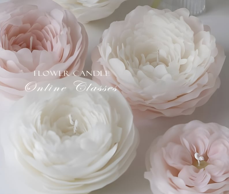 May include: Close-up of four white and pink flower-shaped candles. The candles are arranged in a semi-circle on a white surface. The text "FLOWER CANDLE Online Classes" is visible in the center of the image.