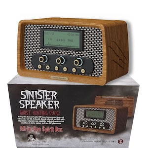 May include: A wooden-look speaker with a black and white mesh front, displaying an FM radio frequency. The speaker is labeled "Sinister Speaker" and "Ghost Hunting Device" on the box. It has a digital display and control knobs.