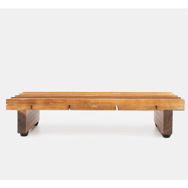 May include: A wooden bench with a slatted top and four legs. The bench is made of dark brown wood and has a natural finish.