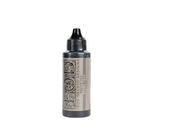 May include: A 2 fl oz bottle of Iron Orchid Designs Decor Ink in the color Stone Gray. The bottle has a black label with the company name and product information.