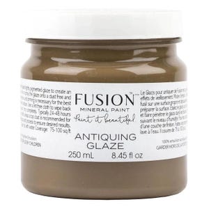 May include: A 250 ml bottle of Fusion Mineral Paint Antiquing Glaze in a brown color. The bottle label reads "Paint it beautiful." and includes instructions for use in both English and French.