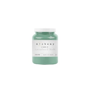 May include: A jar of Alchemy paint in Juniper, a blend of limestone and chalk. The jar is a light teal color with a white lid. The label reads "Alchemy" and "Limestone & Chalk". The paint is by Fusion.
