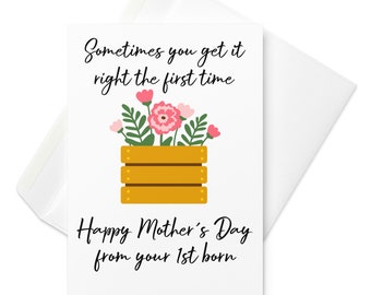 May include: A white card with a yellow wooden crate filled with pink flowers and green leaves. The text on the card reads "Sometimes you get it right the first time. Happy Mother's Day from your 1st born."