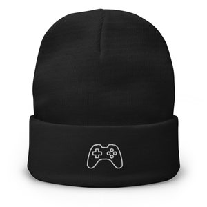 May include: Black beanie with a white embroidered video game controller design.
