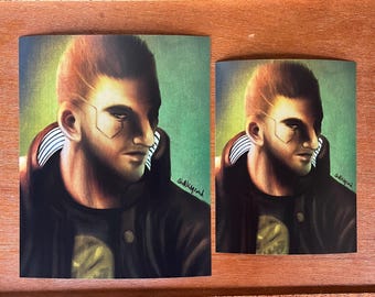 May include: Two art prints featuring a portrait of a person with short, reddish-brown hair and a serious expression. The person is wearing a black jacket with white stripes on the collar. The background is a gradient of green and yellow.