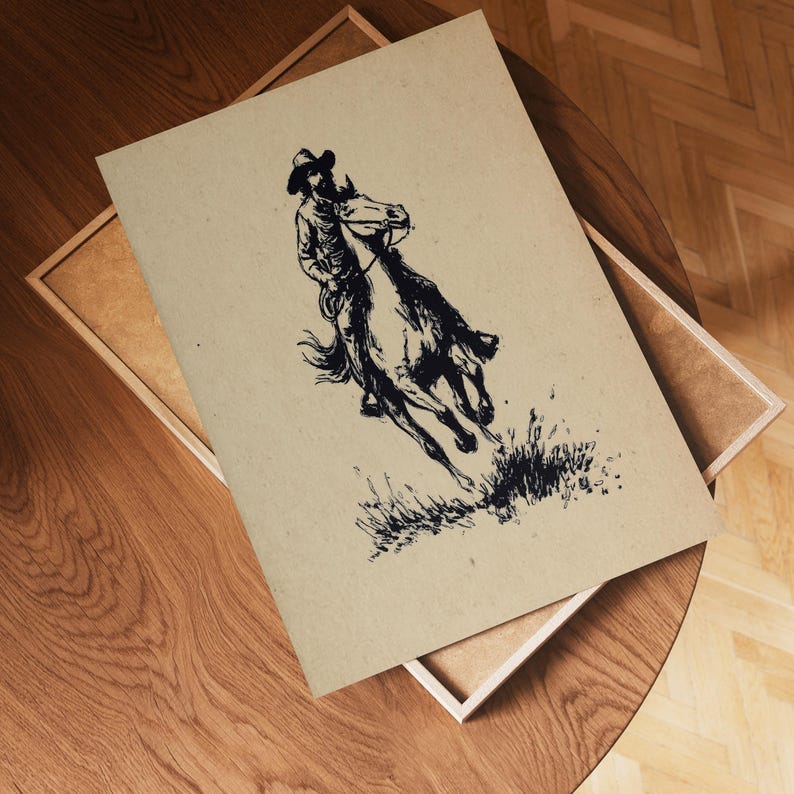 May include: A rectangular print on light tan paper featuring a black ink illustration of a person wearing a cowboy hat riding a galloping horse through tall grass. The artwork displays high contrast lines and a textured, natural paper background.