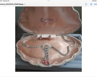 A vintage rhinestone jewellery set in its original velour box. The set includes a necklace and earrings. Would make a great gift.