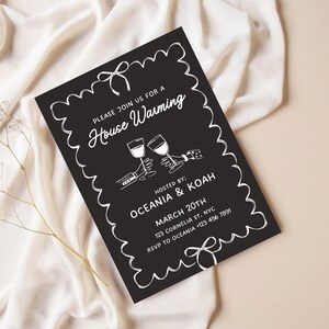 May include: Black and white housewarming invitation with a decorative border. The invitation reads "Please join us for a House Warming" and includes the names "Oceania & Koah", the date "March 20th", the address "123 Cornelia St. NYC", and the RSVP information "RSVP to Oceania +123 456 7891".