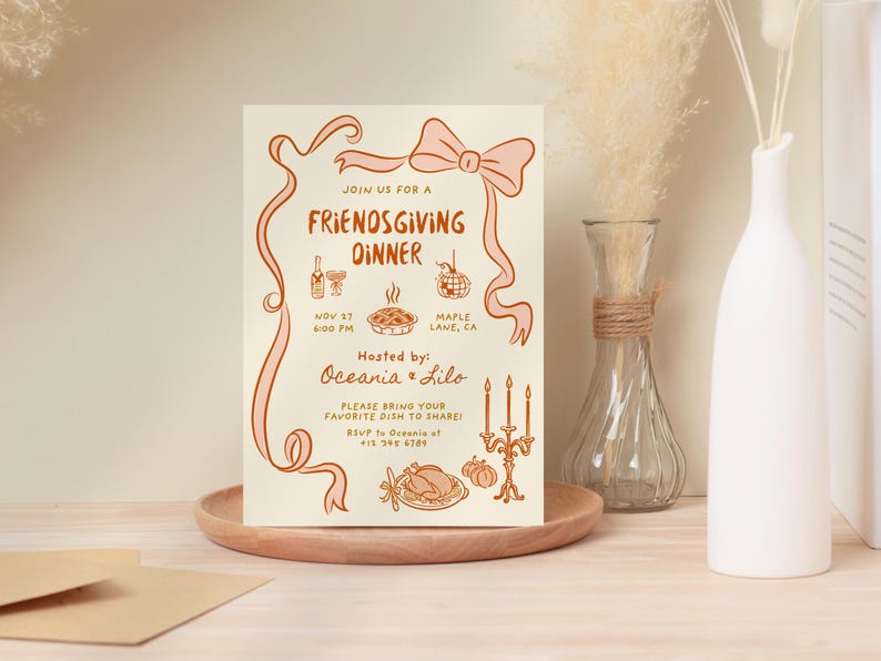 May include: A Friendsgiving dinner invitation on cream-colored paper with orange illustrations and text. The invitation includes a bow, ribbon, and illustrations of food and drinks. The text reads "Join us for a Friendsgiving Dinner" and includes the date, time, and location.