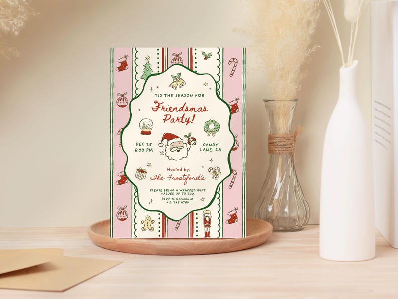 May include: A festive Christmas party invitation with a pink and white striped background. The invitation features holiday-themed illustrations and text that reads "Friendsmas Party!" with the date and time. The invitation is on a wooden tray.