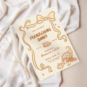 May include: A cream-colored Friendsgiving dinner invitation with orange-brown illustrations. The invitation includes text, a bow, ribbons, a turkey, and a cornucopia. The text reads "Join us for a Friendsgiving Dinner" and includes the date, time, and host's name.