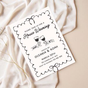 May include: Black and white housewarming invitation with a hand-drawn illustration of two glasses of wine clinking. The text reads "Please join us for a House Warming", "Hosted by: Oceania & Koah", "March 20th", "123 Cornelia St. NYC", and "RSVP to Oceania +123 456 7891".