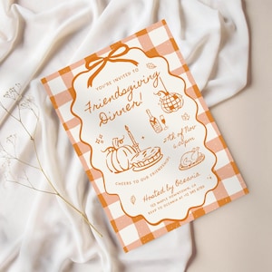 May include: A rectangular invitation card with an orange and white gingham pattern border. The center features orange line art of a pumpkin, pie, turkey, disco ball, and champagne. Text reads: You're invited to Friendsgiving Dinner! 27th of Nov 6:00pm.