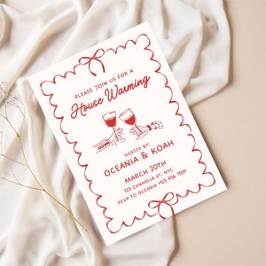 May include: A red and white housewarming invitation with a decorative border. The invitation features a hand-drawn illustration of two people toasting with wine glasses. The text reads "Please join us for a House Warming Hosted by: Oceania & Koah March 20th 123 Cornelia St. NYC RSVP to Oceania +123 456 7891"