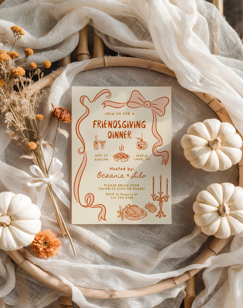 May include: A Friendsgiving dinner invitation with a bow and ribbon design. The invitation includes text, illustrations of food, and the names of the hosts. White pumpkins and dried flowers surround the invitation.
