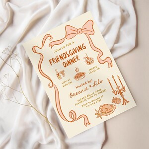 May include: A cream-colored Friendsgiving dinner invitation with a pink ribbon design. The invitation includes the text "Join us for a Friendsgiving Dinner" and details like the date, time, and location. Decorative illustrations of food and drinks are also included.
