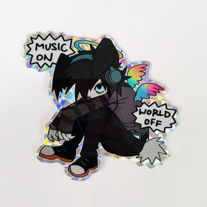 May include: A sticker featuring a cartoon character with black hair, wearing headphones and a purple shirt, sitting with their legs crossed. The character has rainbow wings and a halo. The sticker has a holographic finish and includes the text "Music On" and "World Off".