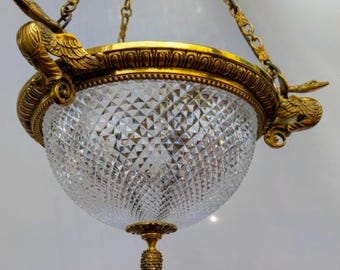 May include: A gold-toned crystal chandelier with a geometric pattern and two bird-shaped accents.