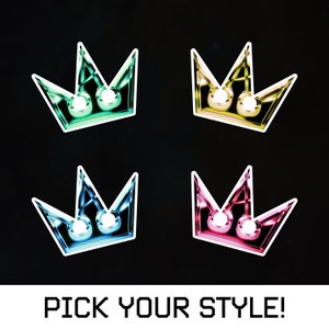 May include: Four stylized crown designs in different colors: green, yellow, blue, and pink. The text "PICK YOUR STYLE!" is at the bottom of the image.