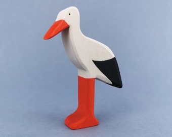 Wooden toy figurine of a white Stork with a red beak