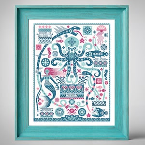 May include: A framed cross-stitch art piece featuring a teal octopus, mermaid, and other sea creatures in shades of teal, pink, and white. The artwork includes the words "Gloucester Sea Monster," "Kraken," and "Mermaid."