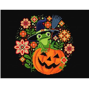 May include: A green frog wearing a witch's hat sits on top of a carved orange pumpkin with a spooky face. The pumpkin is surrounded by colorful flowers and leaves on a black background.