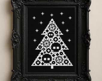 May include: A framed cross-stitch art piece featuring a white Christmas tree design on a black background. The tree is decorated with geometric shapes and snowflakes. The frame is black and ornate.