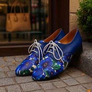 Women’s classic leather lace-up flats featuring elegant blue flower pattern.